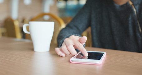 Woman use of mobile phone in coffee shop