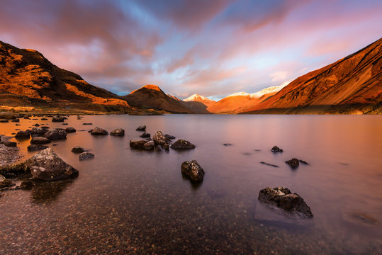 Dramatic sunset red light on snowcapped mountains at Wastwater in the English Lake District.