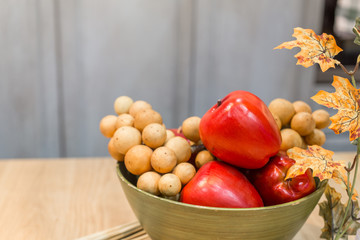 Red apples decorative on table with vintage wooden wall