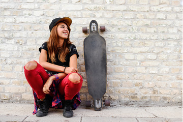Cute trendy urban girl with longboard outdoors © lordn