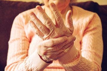 Close up of mature womans hands. Health care giving, nursing home. Parental love of grandmother....