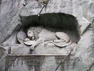 Rock relief of lion monument in stone wall in swiss city of Lucerne in Switzerland