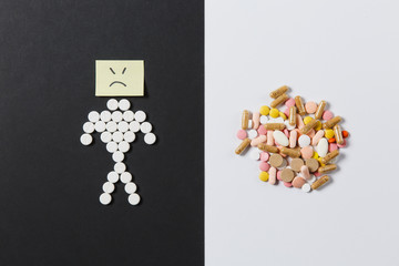 Medication white colorful round tablets arranged abstract on white black background. Human sad, aspirin, capsule pills design. Treatment choice healthy lifestyle concept. Copy space for advertisement.