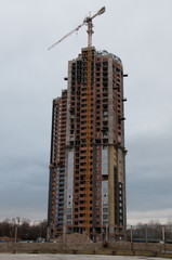 Construction of the building in bad weather. Concept of the difficulty of building business