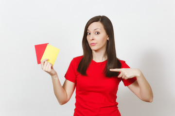 European serious severe young woman, football referee hold choose yellow and red soccer cards,...