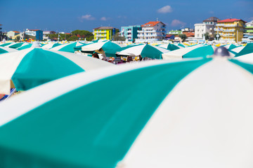 Fototapeta na wymiar Italian beach with umbrellas and hotels