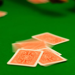 Poker cards falling on Green Table