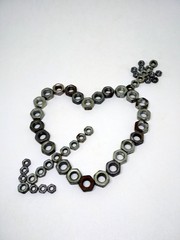 metal heart permeated with an arrow of cupid