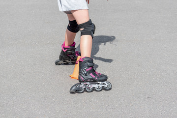 Little girl doing rollerblade in the street