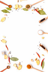 Seasoning background. Dry spices near ginger, garlic, rosemary, chili, laurel leaf on white background top view copy space