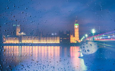 Fototapeta na wymiar Big Ben view through the window with raindrops at night, London, UK.