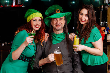 young celebrate Patrick day fun bar carnival headgear girl man beer cocktail green clothes hat smile beautiful leprechaun