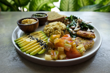 Vegan tofu with avocado, bread, vegetables and source close-up on a plate. Concept of eco healthy diet