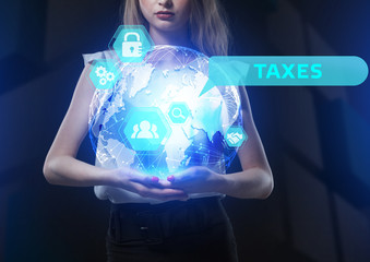 The concept of business, technology, the Internet and the network. A young entrepreneur working on a virtual screen of the future and sees the inscription: Taxes