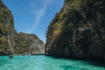 Fototapeta na wymiar boats floating on transparent blue water at Phi-Phi island, Thailand