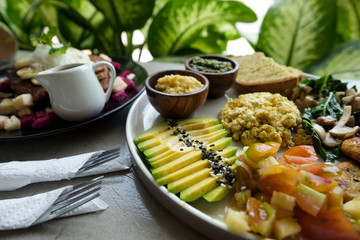 Vegan tofu with avocado, bread, vegetables and source close-up on a plate. Concept of eco healthy diet