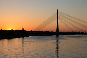 Fototapeta na wymiar City river supping at sunset