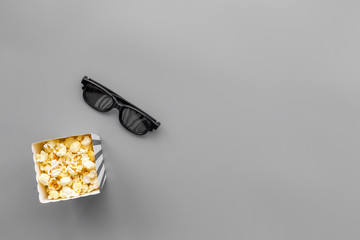 Watch film in cinema concept. Popcorn and glasses on grey background top view copy space