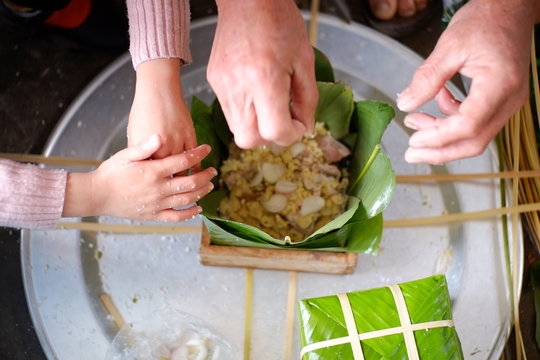 Packing Banh Chung (sticky rice cake), this is a traditional Vietnamese rice cake which is made from glutinous rice, mung beans, pork and other ingredients.