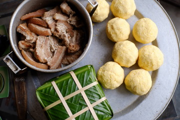 Packing Banh Chung (sticky rice cake), this is a traditional Vietnamese rice cake which is made from glutinous rice, mung beans, pork and other ingredients.