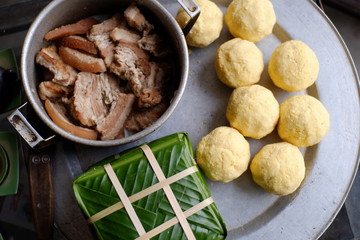 Packing Banh Chung (sticky rice cake), this is a traditional Vietnamese rice cake which is made from glutinous rice, mung beans, pork and other ingredients.