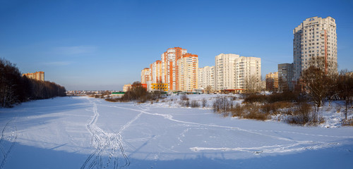 Panoramic view of the new residential neighborhood on the banks of the river Pekhorka in winter. City of Balashikha, Moscow region, Russia.