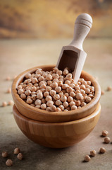 Raw organic chickpeas in a wooden bowl, healthy vegan vegetarian food ingredient.