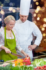 happy male chef cook with woman cooking in kitchen
