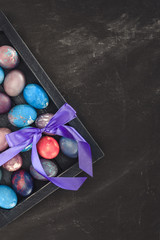 top view of traditional easter eggs in gift box with bow