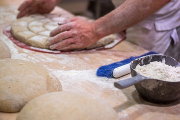 Baker at a bakery preparing bread
