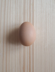 Chicken egg on wooden background.