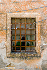 Fototapeta na wymiar Old window with rusty grid