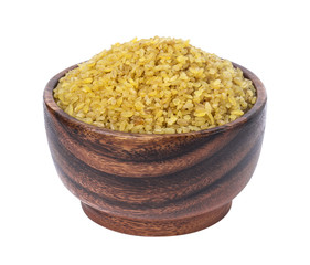 Dry bulgur wheat in wooden bowl isolated on white background