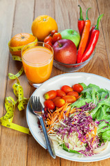 Healthy concept with mixed fruits and vegetables on wooden background