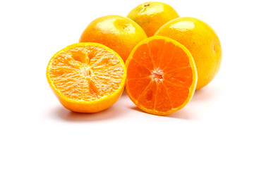 Fresh orange cut in half on a white background.