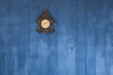 blue wooden wall with wall clock
