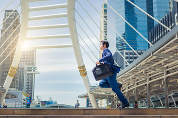 Business man run to work and carry bag in rush hour