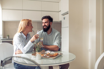 Couple eating pizza snack at home