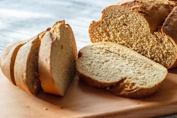 On a wooden background rye bread sliced close-up.