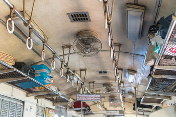 Fan and rail in Thailand vintage train cabin.