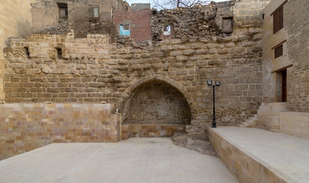 Courtyard of Tekkeyet Al-Bustami with big embedded niche mediating stone bricks wall, Cairo, Egypt