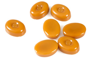 milk caramel candies isolated on white