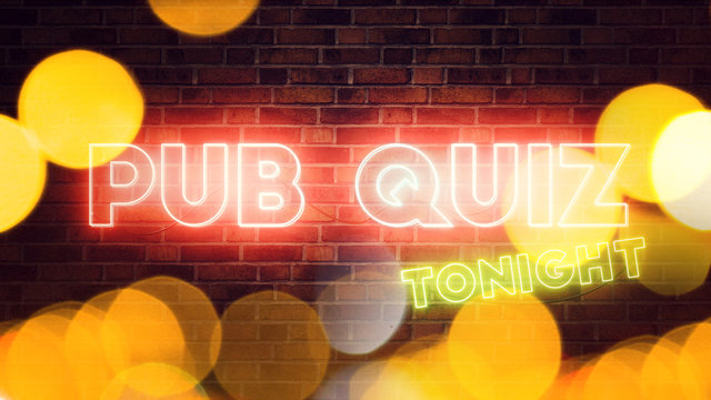 Pub Quiz Neon Sign Mounted On Brick Wall