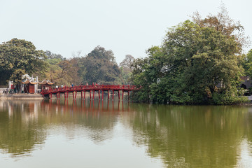 Obraz premium Red Bridge at Hoan Kiem Lake with tress and reflected shadow in Hanoi, Vietnam.