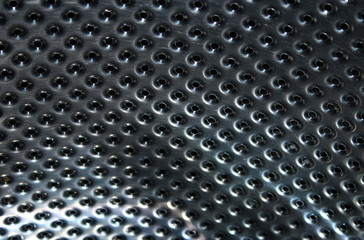 Metal surface with holes of different diameters
