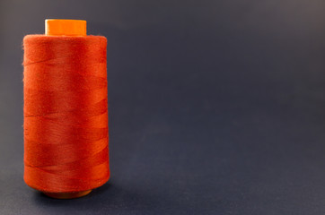 Red skein of thread on a blue background