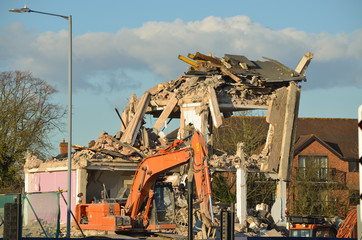 derelict building with industrial digger