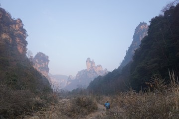 Mountains in China with trees and dust in sunshine