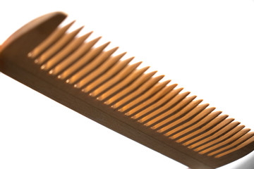 Thin comb of light wood on a white background