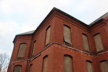 Fototapeta na wymiar Abandoned brick asylum hospital building